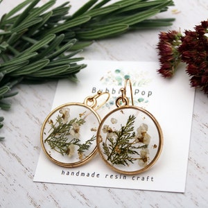 Gold hoop resin flower earrings with pressed white and green dried blooms