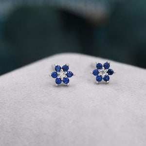 Tiny blue CZ flower stud earrings with silver posts