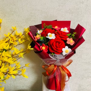 Crochet flower bouquet with red rose ornaments, wrapped with red satin ribbon and bow