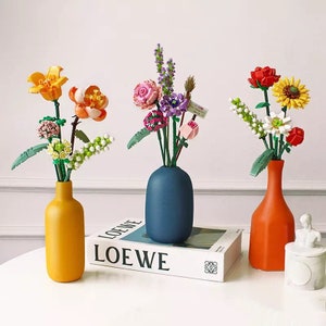 Flower building block set with assembled blooms in three vases and gift box