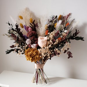 Rainbow dried flower bridal bouquet with mixed blooms and ribbon tie