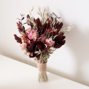 Mini boho dried flower bouquet with burgundy, pink, and cream blooms, tied with twine