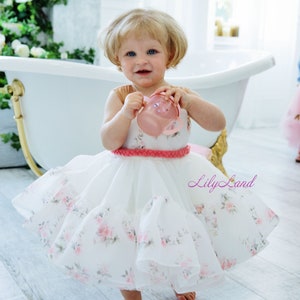 White floral toddler tutu dress with layered tulle skirt and pink bow straps
