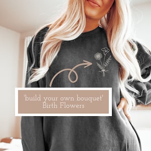 Charcoal crewneck sweatshirt with embroidered bouquet and arrow motif, birth flower design