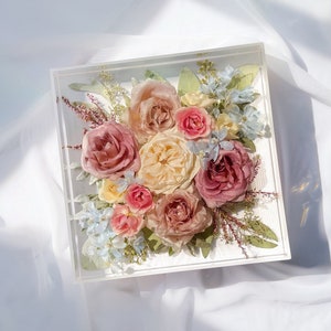 Square resin floral keepsake block with preserved pink, cream roses and greenery inside