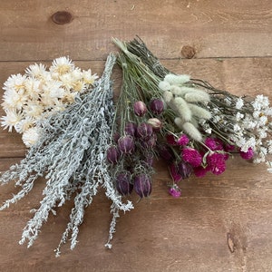 DIY dried flower kit with white and purple dried flower bunches and soft grey greenery