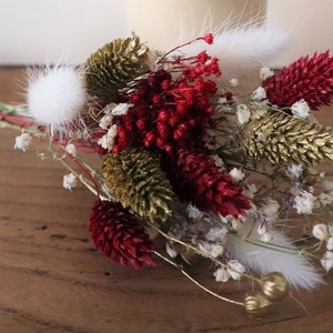 Dried Christmas flower bouquet with pine cones, red blooms, and white bunny tails
