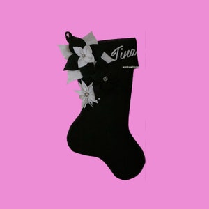 Black felt Christmas stocking with white flower applique and stitched name label