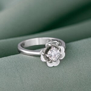 Gold-tone flower-shaped moissanite ring with central round crystal and scalloped petals