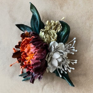 Leather wedding brooch with dark green leaves, red-orange and white leather flowers
