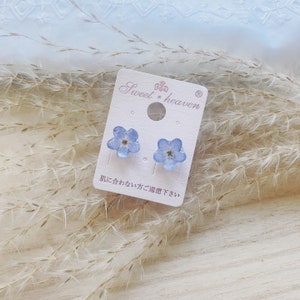 Forget-me-not pressed flower stud earrings, light blue, on display card