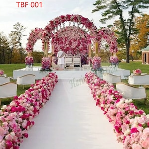 Artificial flower aisle runner with fuchsia and pink silk blooms and floral arch