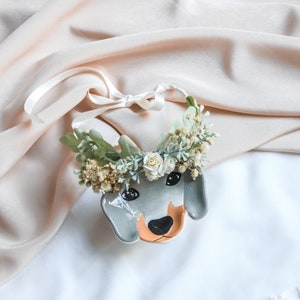 Dog flower crown collar with green and white blooms and dangling heart charms
