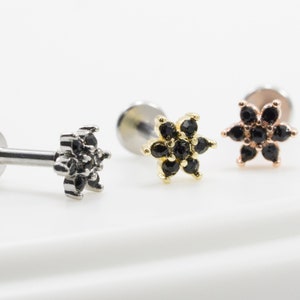 Cubic flower cartilage piercing set with three threaded posts and black/gold stone flowers