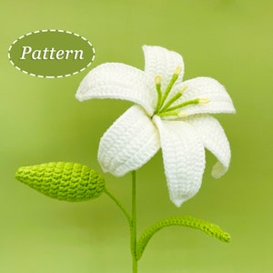 White crocheted flower with wrapped petals and green leaf, on a single stem