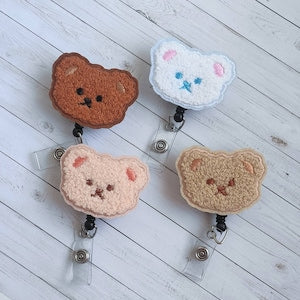 Fuzzy bear badge reels with retractable clips, plush bear faces in brown and cream