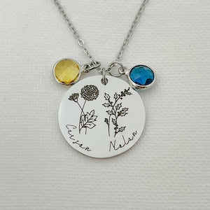 Silver-tone birth flower necklace with oval pendant, engraved names, yellow and blue stones