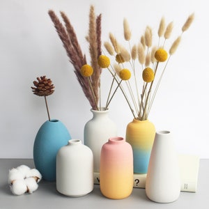 Set of small ceramic bud vases in blue, white, pastel pink, and yellow