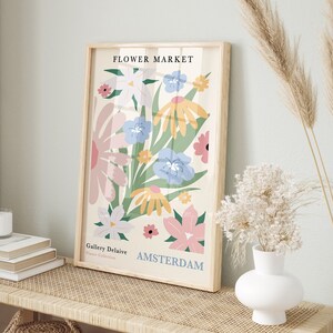 Framed floral wall art print with pastel flowers and Amsterdam lettering