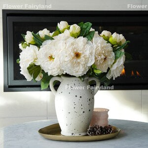 Artificial peony flower bouquet with bud stems in a white speckled vase