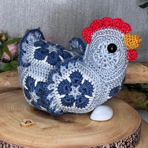 Crocheted chicken figurine, blue and white with large flower motifs, red comb