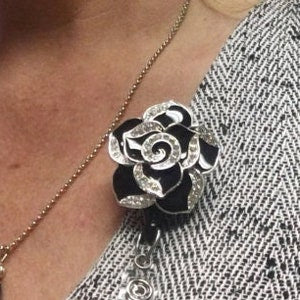 Black enamel flower retractable badge reel with round clip and keychain loop