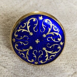 Blue enamel button ring with gold floral filigree and star detail