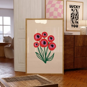 Framed floral wall art print with red circle flowers and green stems on cream background