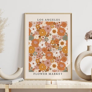 Framed flower market wall art print with orange and white daisies; 'Los Angeles' text.
