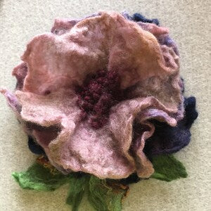Handmade wool felt rose flower pin with layered pink petals and green leaf accents