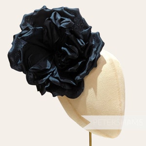 Black silk rosette fascinator on light hat mount base, floral flower headpiece
