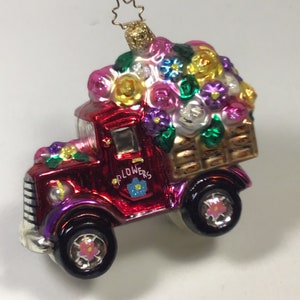 Colorful glitter truck spring ornament with red body, purple and green accents, shiny wheels