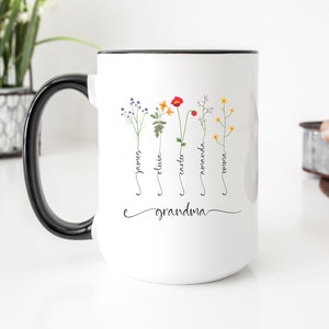 White ceramic mug with black handle; names on flower stems; 'grandma' lettering