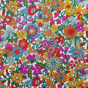 Floral cotton lawn fabric in pink and yellow with multicolor flower print