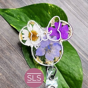 Mouse-shaped floral badge reel with purple flowers and metal retractable clip