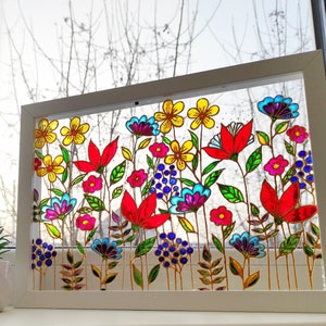 Colorful pressed-flower stained glass sun catcher in a rectangular frame