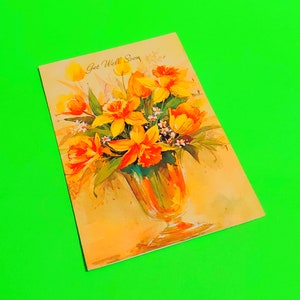 Floral get well greeting card with orange daffodil bouquet in a vase