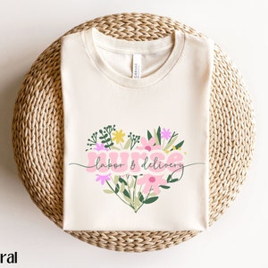 Cream nurse shirt with colorful floral bouquet graphic on front