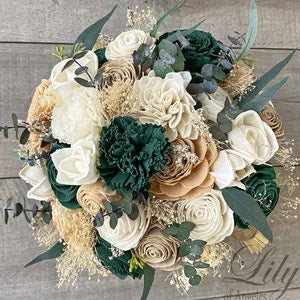 Bridal bouquet with cream and blush sola flowers, dark green blooms, and eucalyptus sprigs