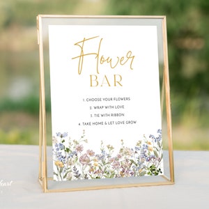 Framed flower bar sign with golden “Flower Bar” text and wildflower border