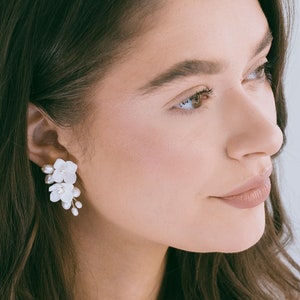 White floral dangle earrings with small clay flowers