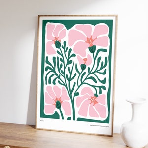 Framed abstract floral wall print with pink blossoms and green stems on teal background