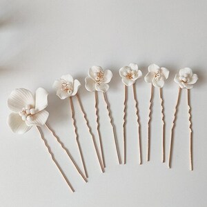 White floral hair pins set with gold-tone stems, small boho flower hair accessories