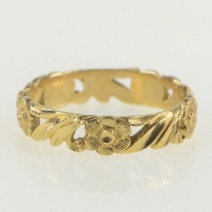 Thin gold ring band with engraved floral and leaf design on top