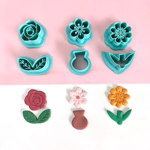 Polymer clay flower cutter set with embossed flower and leaf shapes, in teal and red