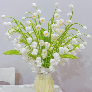Crochet lily of the valley flower bouquet with white bells and green stems in vase