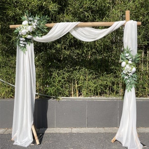 Artificial floral wedding swags with white sheer drapes and white peony blooms