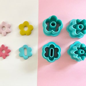 Teal flower-shaped polymer clay cutters set, various sizes and petal details