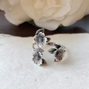 Sterling silver adjustable dogwood flower ring with three floral blooms, open band