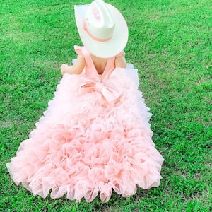 Peach ombre flower girl dress with layered ruffle skirt, bow bodice, and train